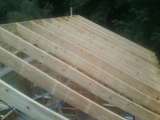 New roof rafters set over an addition before sheathing in Sauk Centre